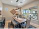 Beautiful dining room featuring a rustic wood table, bench seating, and modern light fixture at 706 E La Palta St, Queen Creek, AZ 85140