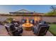 Backyard fire pit area with comfortable seating, perfect for outdoor gatherings and relaxation at 706 E La Palta St, Queen Creek, AZ 85140