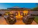 Outdoor fire pit surrounded by comfortable seating, creating a cozy backyard gathering space at 706 E La Palta St, Queen Creek, AZ 85140