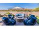 This outdoor fire pit is surrounded by comfortable seating for outdoor relaxation and entertainment at 706 E La Palta St, Queen Creek, AZ 85140