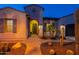Inviting home entrance with decorative shutters, arched entry, desert landscaping, and a pathway at 706 E La Palta St, Queen Creek, AZ 85140