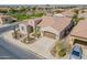 Beautiful aerial view of a home with a desert landscape front yard, a spacious driveway, and well-maintained surroundings at 706 E La Palta St, Queen Creek, AZ 85140