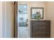 Hallway leading to the living area offers a glimpse of a modern gray sofa, fan, and wall art at 706 E La Palta St, Queen Creek, AZ 85140