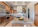 Open kitchen featuring custom cabinets, granite counters and stainless steel appliances at 706 E La Palta St, Queen Creek, AZ 85140