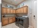 Well-lit laundry room features ample cabinet space, folding counter, modern washer and dryer, and decorative accents at 706 E La Palta St, Queen Creek, AZ 85140