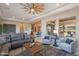 Bright living room overlooking the kitchen featuring a ceiling fan, a large window, and neutral decor at 706 E La Palta St, Queen Creek, AZ 85140