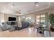 A spacious living room features a large window, a sliding door, a ceiling fan and neutral decor at 706 E La Palta St, Queen Creek, AZ 85140