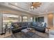 This bright living room showcases a ceiling fan, a large window, a sectional sofa, and recessed lighting at 706 E La Palta St, Queen Creek, AZ 85140