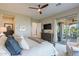 This main bedroom offers patio access, a ceiling fan, and large dresser for ample storage space at 706 E La Palta St, Queen Creek, AZ 85140