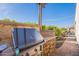 Outdoor kitchen featuring a stainless steel grill and stone accents, creating a perfect outdoor cooking space at 706 E La Palta St, Queen Creek, AZ 85140