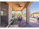 Covered patio featuring an outdoor table and chairs with access to the landscaped backyard at 706 E La Palta St, Queen Creek, AZ 85140