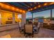 Backyard patio area with outdoor kitchen, pergola, outdoor table and chairs, for outdoor living and entertaining at 706 E La Palta St, Queen Creek, AZ 85140