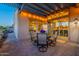Inviting outdoor patio with a pergola, dining set, and views into the home's interior through large sliding glass doors at 706 E La Palta St, Queen Creek, AZ 85140