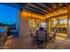 Inviting patio with a pergola, an outdoor dining set, and views into the home at 706 E La Palta St, Queen Creek, AZ 85140