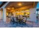 Outdoor patio with stone flooring, dining table, seating, and a covered area for evening enjoyment at 706 E La Palta St, Queen Creek, AZ 85140