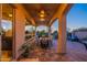 Covered outdoor patio featuring a dining table, fan, and views of the well-manicured backyard at 706 E La Palta St, Queen Creek, AZ 85140