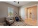 Relaxing sitting room with two armchairs, a small table, and a window with natural light at 706 E La Palta St, Queen Creek, AZ 85140