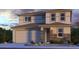 Two-story home showcasing a 2-car garage, stone accents, and a mix of window styles at 8817 W Windsor Blvd, Glendale, AZ 85305