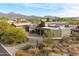 Aerial view of luxury home with desert landscaping and mountains in the background at 8845 E Sierra Pinta Dr, Scottsdale, AZ 85255