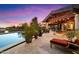 Backyard with a swimming pool, a lounge chair, and a covered patio with outdoor seating at 8845 E Sierra Pinta Dr, Scottsdale, AZ 85255