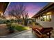 Desert backyard with custom lighting, desert landscaping, and lounge seating at 8845 E Sierra Pinta Dr, Scottsdale, AZ 85255