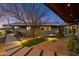 Desert backyard with artificial turf, desert landscaping, and custom pathway lighting at 8845 E Sierra Pinta Dr, Scottsdale, AZ 85255