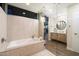 Modern bathroom features a soaking tub with stone accents, a glass shower, and a sleek vanity with illuminated mirror at 8845 E Sierra Pinta Dr, Scottsdale, AZ 85255