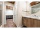 Stylish bathroom featuring wood cabinets, a white countertop, and glass shower at 8845 E Sierra Pinta Dr, Scottsdale, AZ 85255