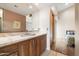 Bathroom featuring a wood vanity with marble countertop, a sink, and large mirror at 8845 E Sierra Pinta Dr, Scottsdale, AZ 85255