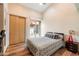 Bright bedroom features light-colored walls, wood flooring, and a sliding glass door to the outside at 8845 E Sierra Pinta Dr, Scottsdale, AZ 85255