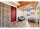 Versatile bonus room with wood-look tile flooring, a beamed ceiling, and a comfortable seating area at 8845 E Sierra Pinta Dr, Scottsdale, AZ 85255