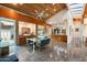 Bright dining area featuring glass table and modern chairs, wood ceiling and connection to kitchen at 8845 E Sierra Pinta Dr, Scottsdale, AZ 85255