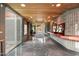 Elegant home foyer with a stone floor, wood ceiling, and art display and glass doors to outside at 8845 E Sierra Pinta Dr, Scottsdale, AZ 85255
