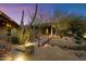 Front yard with desert landscaping and lit pathway leading to the home's entry at 8845 E Sierra Pinta Dr, Scottsdale, AZ 85255