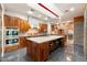 Modern kitchen features a large island, a stainless steel hood, and dark countertops at 8845 E Sierra Pinta Dr, Scottsdale, AZ 85255