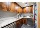 Butler's pantry with granite countertops, a mosaic backsplash, and wood cabinets at 8845 E Sierra Pinta Dr, Scottsdale, AZ 85255