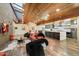 Bright open-concept living area showcasing a gourmet kitchen, unique wood ceiling, and designer touches throughout at 8845 E Sierra Pinta Dr, Scottsdale, AZ 85255