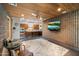 Living room with concrete walls, wood ceilings, and a view into the kitchen and breakfast nook at 8845 E Sierra Pinta Dr, Scottsdale, AZ 85255