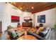 Cozy living room featuring hardwood floors, beamed ceiling, comfortable seating and modern art at 8845 E Sierra Pinta Dr, Scottsdale, AZ 85255