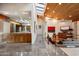 Open concept living space with stone floors, wood ceilings, access to dining and living areas at 8845 E Sierra Pinta Dr, Scottsdale, AZ 85255