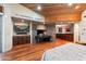 The main bedroom features hardwood floors, built-in cabinets, and a stone-clad fireplace and mantel at 8845 E Sierra Pinta Dr, Scottsdale, AZ 85255