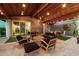 Outdoor space with comfortable seating, wood beams, string lights, and a dining table at 8845 E Sierra Pinta Dr, Scottsdale, AZ 85255