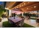 Outdoor living area with wood ceiling, dining table, lounge chairs, and views of lush greenery at 8845 E Sierra Pinta Dr, Scottsdale, AZ 85255