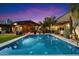 Backyard pool at twilight with a covered patio and lush landscaping at 8845 E Sierra Pinta Dr, Scottsdale, AZ 85255