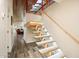 Unique floating staircase with wooden treads and modern lighting, set against a white wall and wood ceiling at 8845 E Sierra Pinta Dr, Scottsdale, AZ 85255