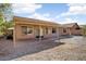 This home features a backyard with a covered patio, rock landscaping, and a desert-friendly design at 8962 W Grovers Ave, Peoria, AZ 85382