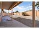 This large backyard features low-maintenance landscaping, a brick wall, and a covered patio area at 8962 W Grovers Ave, Peoria, AZ 85382