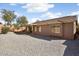 View of the home's backyard, showcasing a low-maintenance landscape and a covered patio area at 8962 W Grovers Ave, Peoria, AZ 85382