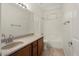 Bathroom features a single sink, solid surface countertops, and a shower-tub combo at 8962 W Grovers Ave, Peoria, AZ 85382