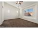 Spacious bedroom with vaulted ceiling, a large window, and plush carpeting throughout at 8962 W Grovers Ave, Peoria, AZ 85382